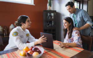 Mister Sparky tech explaining to homeowners where to install smoke detectors in home