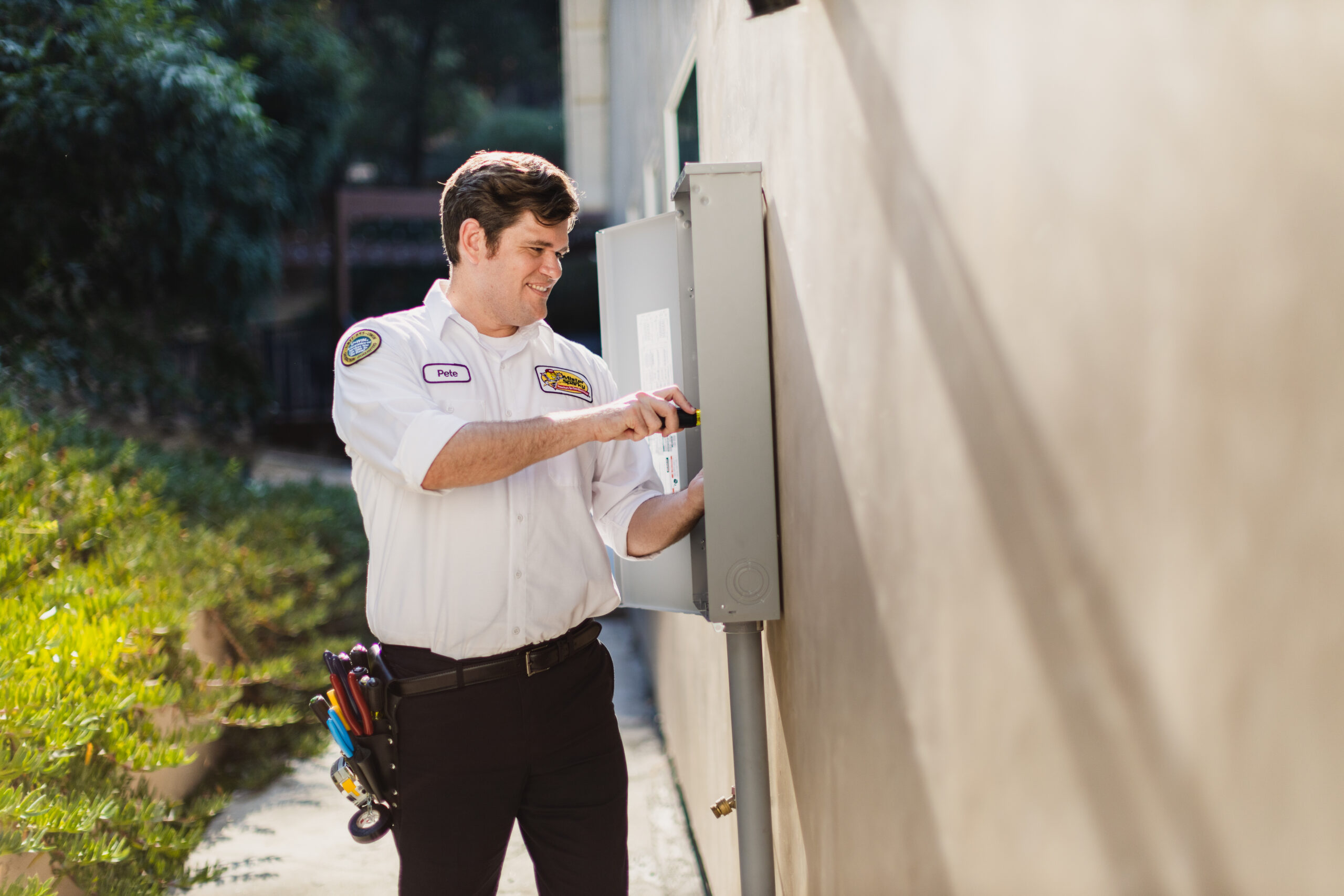 Mister Sparky electrician inspecting electrical panel