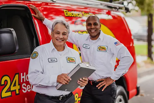 Lakeland Mister Sparky Electrician Techs in front of a service van