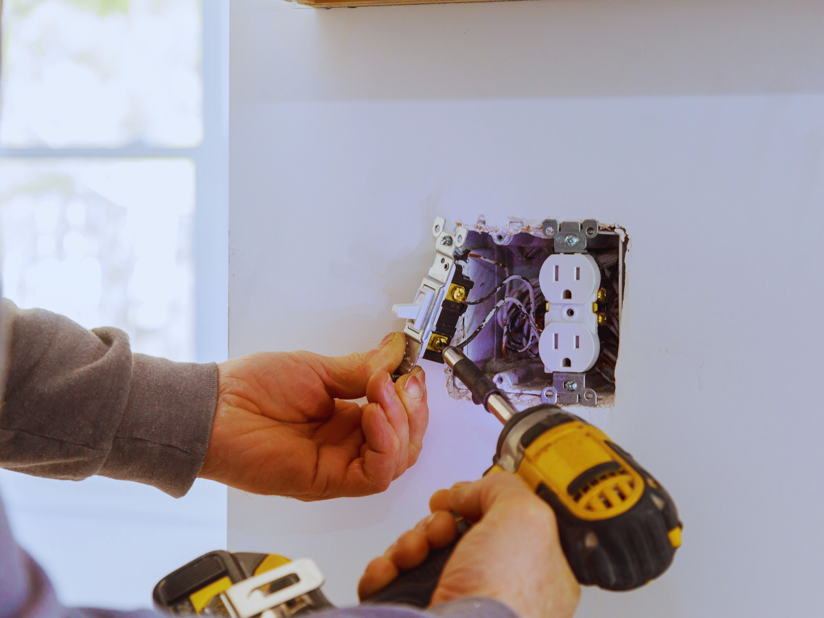Electrician repairing electrical outlets