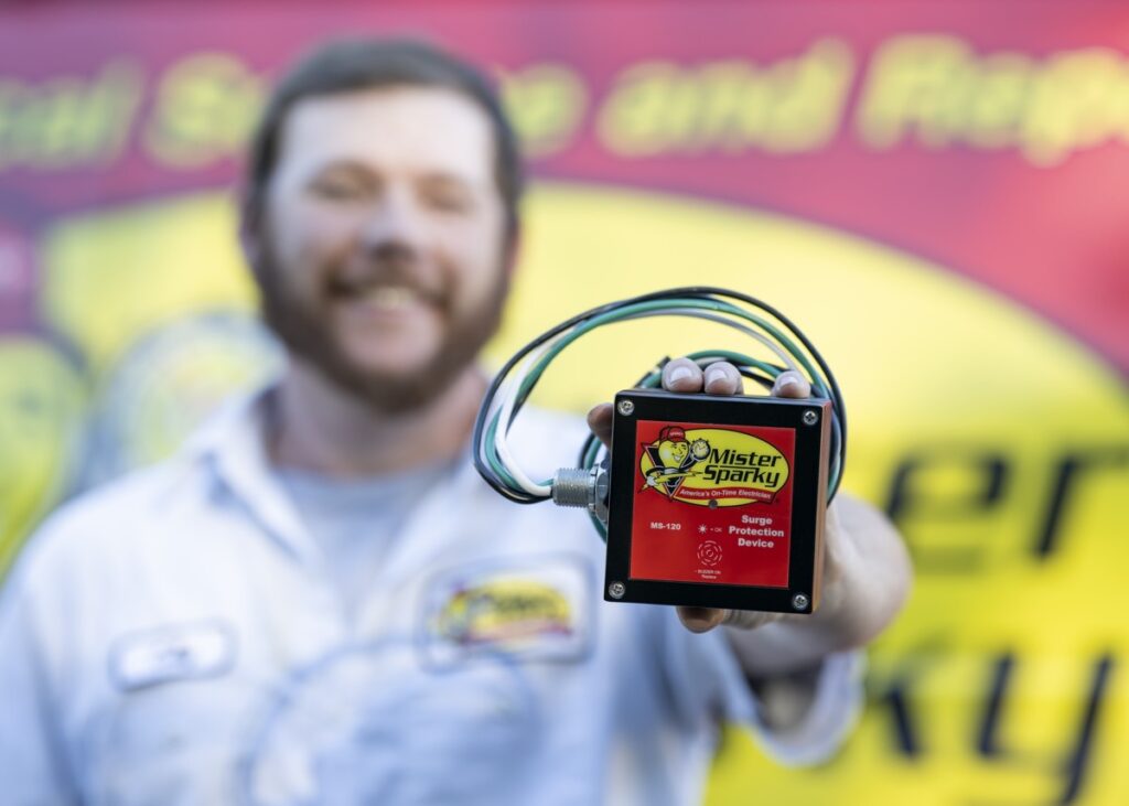 mister sparky employee holding surge protector