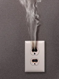Burnt outlet with smoke coming out of it