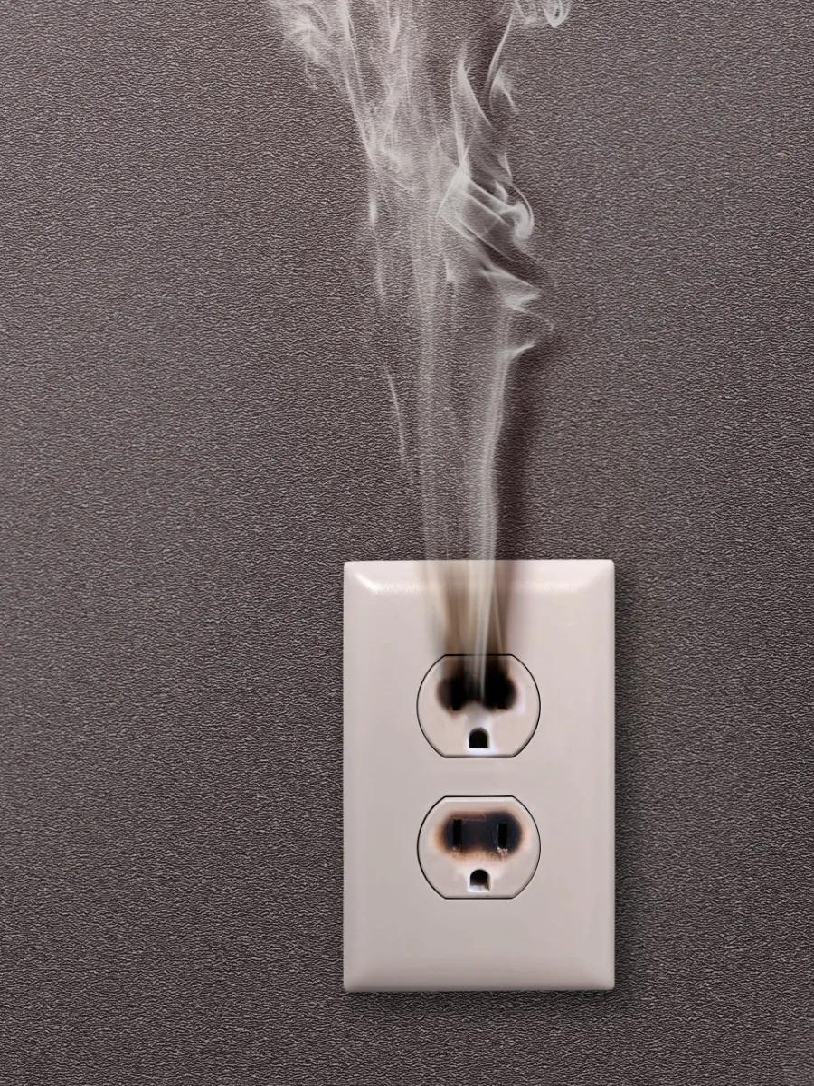 Burnt outlet with smoke coming out of it