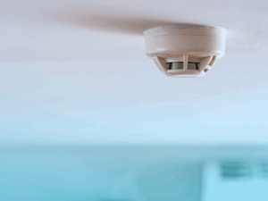 Smoke rising by smoke detector in living room